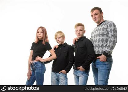 Dad, two sons and a daughter in casual clothes in dark colors, white background