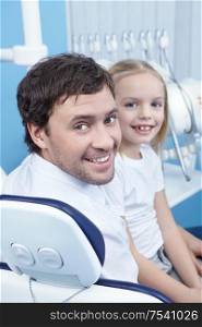 Dad with a child in the dental office