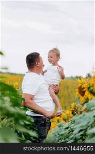 Dad with baby girl outdoors in sunflower field, love. Bonding, family, new life. Warm summer day. family concept. selective focus.. Dad with baby girl outdoors in sunflower field, love. Bonding, family, new life. Warm summer day. family concept. selective focus