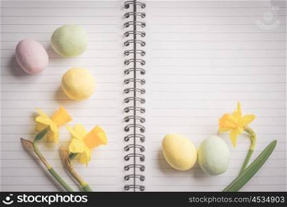 Daffodils and easter egg decoration on linear paper