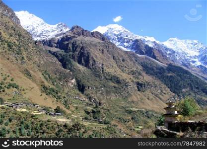 Dagoba and village in mountain in Nepal
