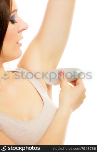 Daily skin care and hygiene. Girl applying stick deodorant in armpit. Young woman putting antiperspirant in underarms on white