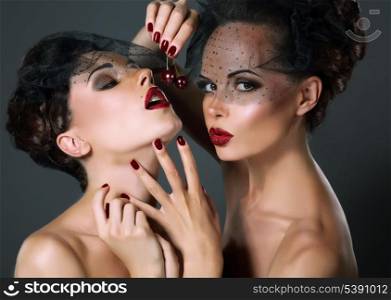 Dainty. Two Provocative Women in Veils with Cherry Berries. Temptation