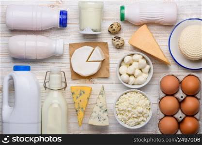 Dairy products assortment flat lay on white wooden table