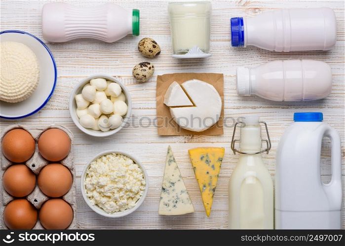 Dairy products assortment on white wooden table flat lay top view
