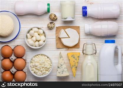 Dairy products assortment on white wooden table flat lay top view