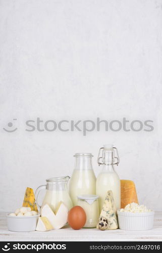 Dairy products assortment on white wooden table vertical composition with copy space