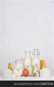 Dairy products assortment on white wooden table vertical composition with copy space
