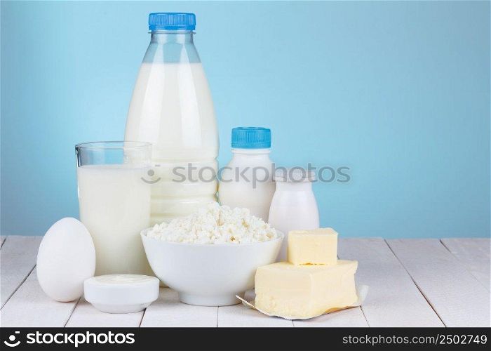 Dairy products assortment on wooden table, with place for text