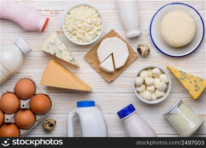 Dairy products grocery assortment flat lay on white wooden table