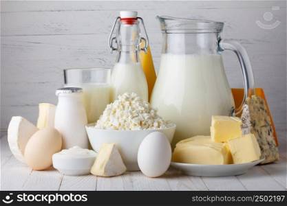 Dairy products, milk, cottage cheese, eggs, yogurt, sour cream and butter on wooden table