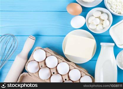 dairy products on blue wooden background, top view