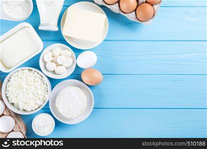 dairy products on blue wooden background, top view