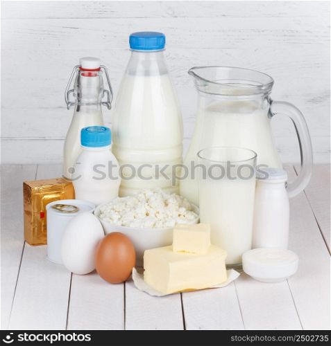 Dairy products on white wooden table still life