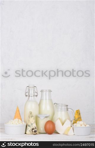 Dairy products on white wooden table vertical composition with copy space