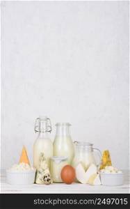 Dairy products on white wooden table vertical composition with copy space