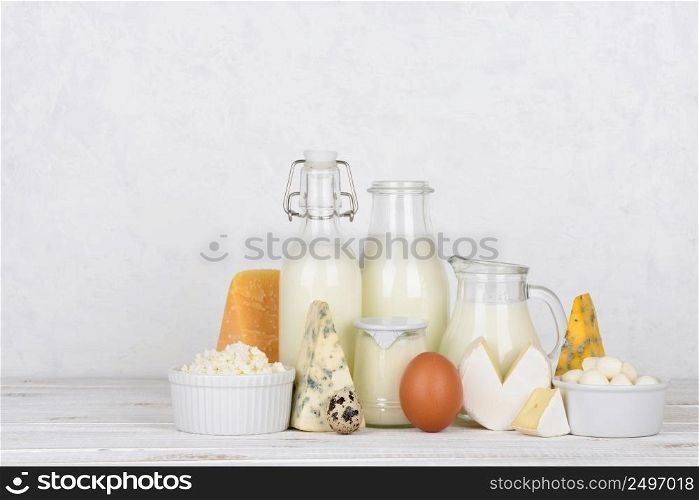Dairy products on white wooden table with side copy space