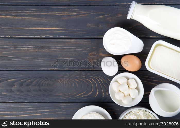 Dairy products on wooden table. Milk, cheese, egg, curd cheese a. Dairy products on wooden table. Milk, cheese, egg, curd cheese and butter.