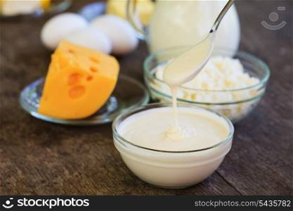 Dairy products on wooden table, selective focus, shallow deep of field