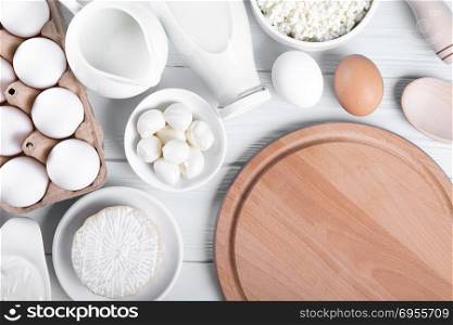 Dairy products on wooden table, top view