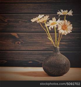 Daisy flowers, beauty still life against old wooden desk