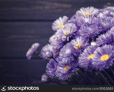 Daisy flowers over old wooden desk, floral backgrounds