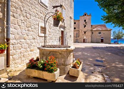 Dalmatian stone architecture and ancient well in Kastel Stafilic, Split region in Croatia