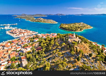 Dalmatian town of Tribunj church on hill and amazing turquoise archipelago aerial view, Dalmatia region of Croatia