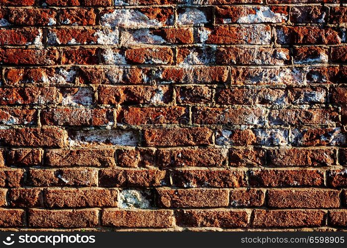 Damaged brick wall covered with spot of salt, home renovation concept