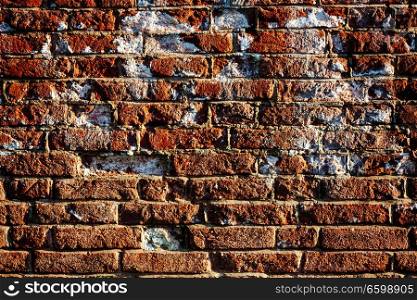 Damaged brick wall covered with spot of salt, home renovation concept