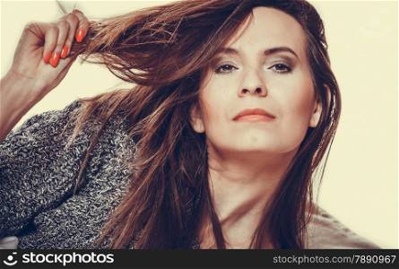 Damaged dry woman hair. Closeup woman holding hand long hair and looking unhappy.