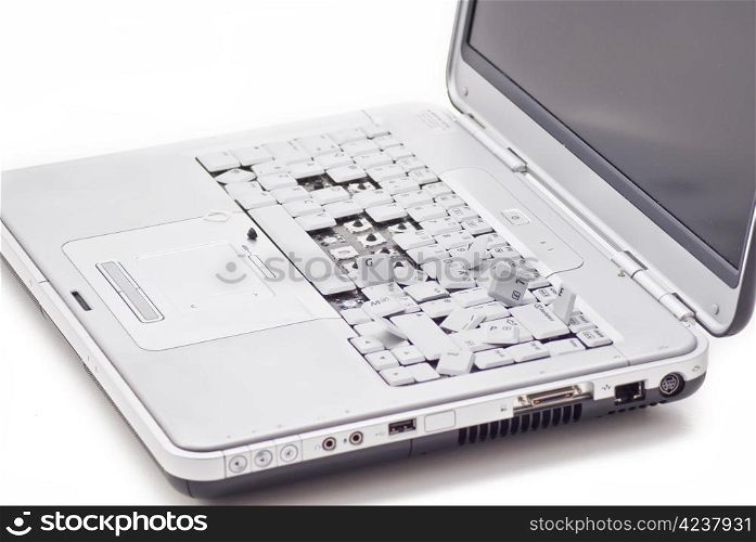 Damged laptop keyboard with teared out keys