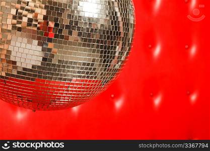 dance mirror ball on red leather background