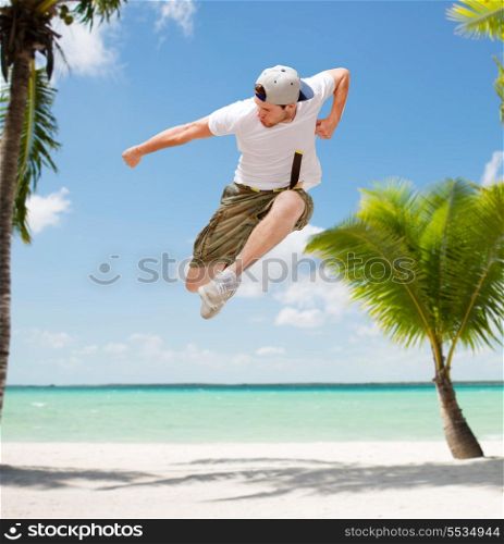 dance, summer and holidays concept - male dancer jumping in the air