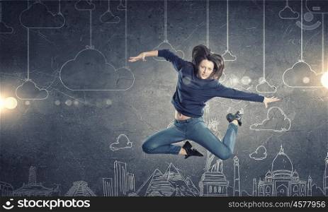 Dancer girl in jump. Young woman dancer jumping in spotlights on sketched background