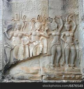 Dancing Apsaras an old Khmer art carvings on the wall in the corridors of Angkor Wat temple, Siem Reap, Cambodia.