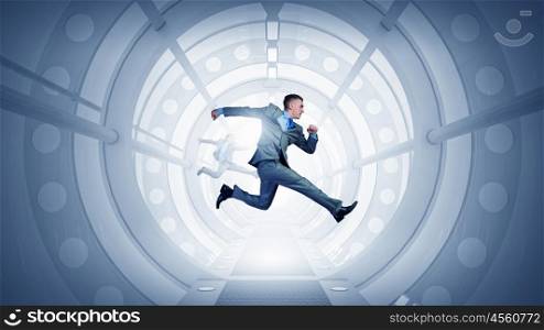 Dancing businessman in office. Young dancing businessman in suit in futuristic interior