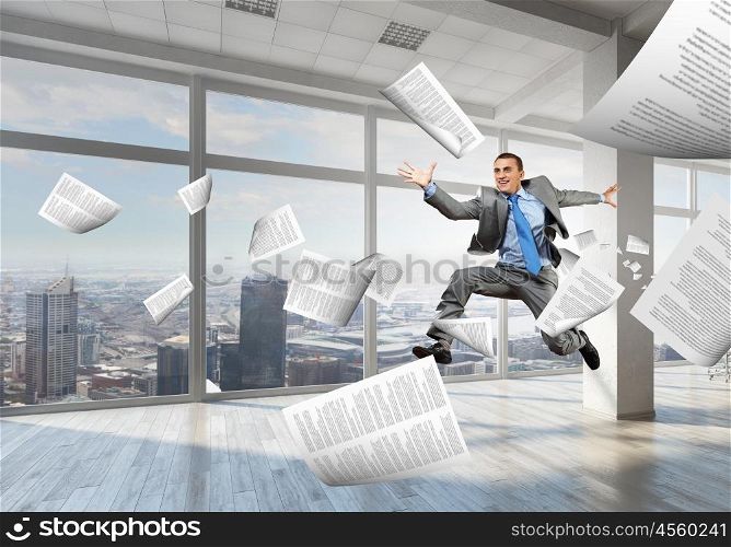 Dancing businessman in office. Young dancing businessman in suit in modern interior