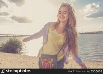 Dancing on the beach. Beautiful girl in the morning on the beach. Vintage looking image