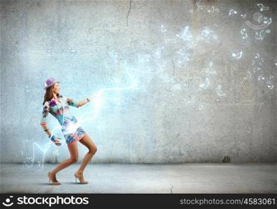 Dancing woman. Young dancing woman in colored dress and hat