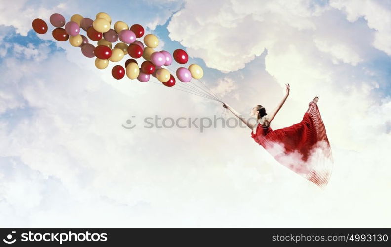 Dancing woman. Young woman in dress and ballerinas dancing with colorful balloons