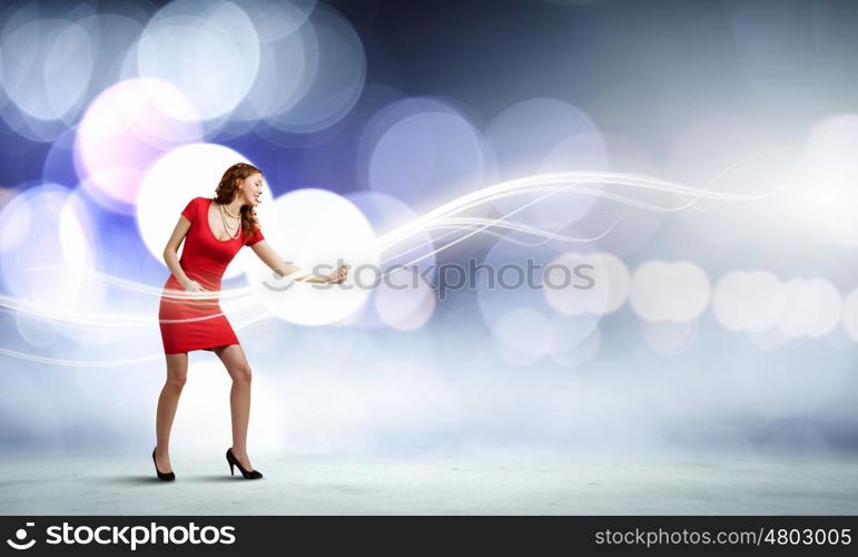 Dancing woman. Young woman in red dress playing guitar