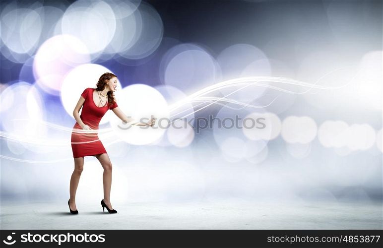 Dancing woman. Young woman in red dress playing guitar
