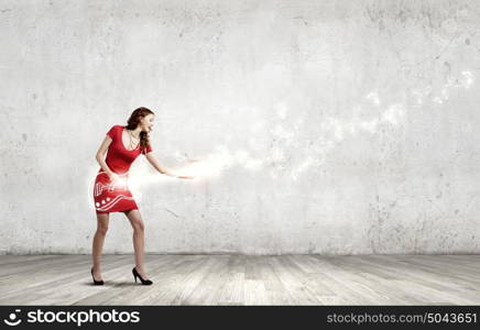 Dancing woman. Young woman in red dress playing guitar