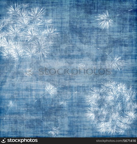 Dandelions over blue, grunge background