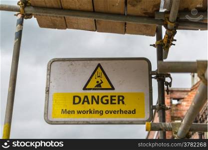 Danger, men working overhead sign on scaffolding