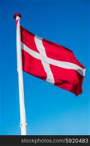 Danish flag on a flag pole in the wind