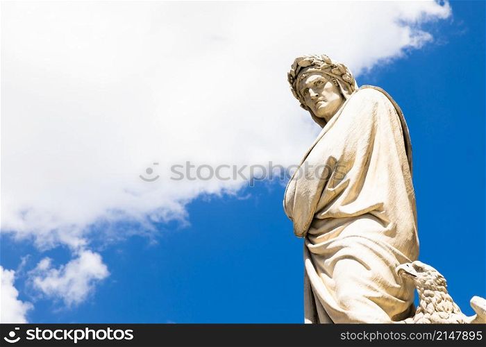 Dante Alighieri statue in Florence, Tuscany region, Italy, with an amazing blue sky background.