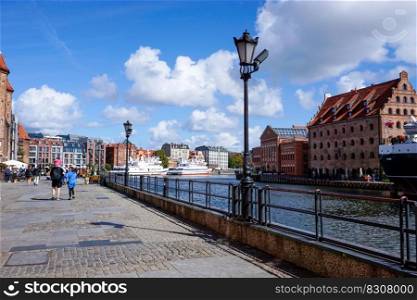 Danzig, Poland - 2 September, 2021: tourists enjoy a visit to the historic city center of Danzig along the boardwalk of the Motlawa River