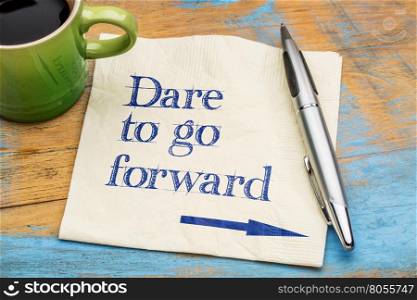 Dare to go forward - handwriting on a napkin with a cup of espresso coffee